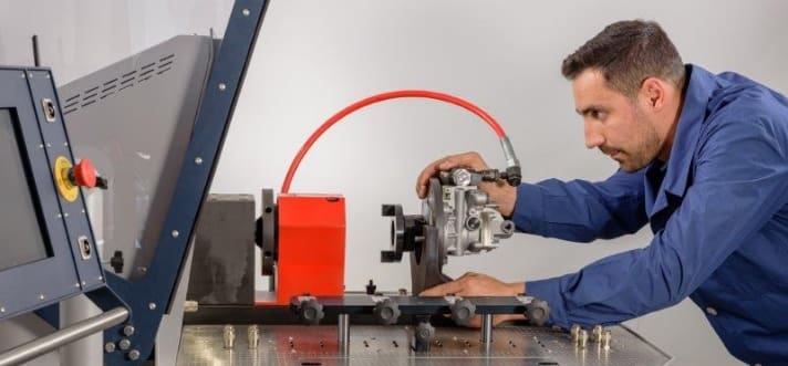 Technician setting up pump on Carbon ZappbMTBRX test bench