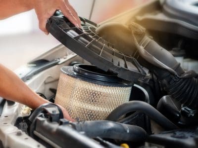 Car mechanic working in repair garage. maintenance checking air filter